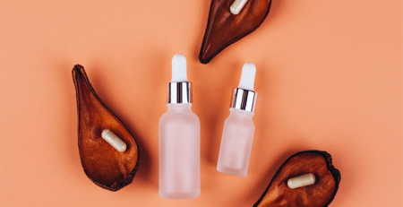 Two bottles of serum and a pair of pears