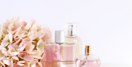 A group of three bottles of perfume next to each other.