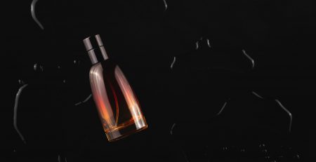 A bottle of alcohol on the ground in dark.